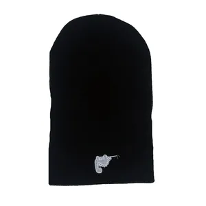 Bonnet en tricot noir d'hiver avec une broderie de dinosaure blanc sur le devant