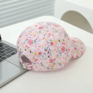 Pink floral print baseball cap for kids with adjustable metal buckle on white background
