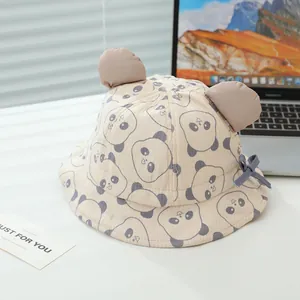 Detail of baby sun hat with panda print, 3D ears and bow on soft cotton fabric