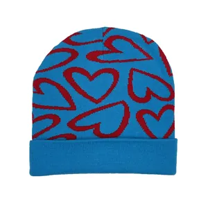 Blue knitted beanie with red heart pattern and folded cuff for autumn winter fashion