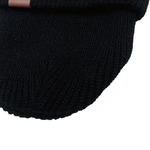 Black ribbed knit baby beanie with brown leather tag accent for winter warmth