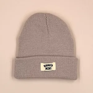 Knitted kids beanie featuring MAMA'S MINI patch in dusty pink with ribbed cuff design
