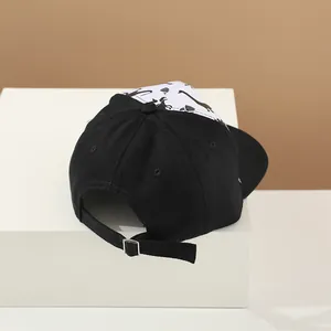 Detail of adjustable back strap and dinosaur silhouette print on cotton baseball cap