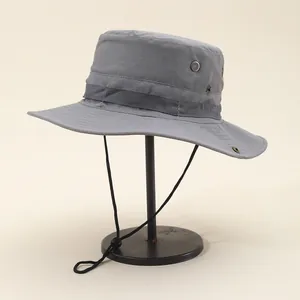 Detail of grey outdoor sun hat featuring breathable metal eyelets and ripstop fabric
