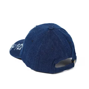 Distressed dark blue denim baseball cap with frayed edges and adjustable metal buckle strap