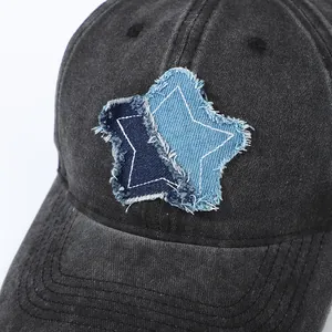 Washed dark gray denim baseball cap with vintage distressed star patches in a side view