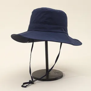 Detail of navy blue sun hat with adjustable windproof drawstring and metal air vents