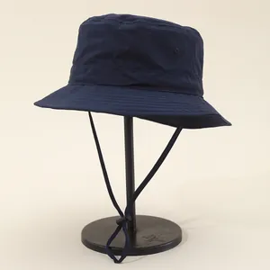 Close-up of waterproof navy bucket hat with adjustable chin cord and breathable eyelets