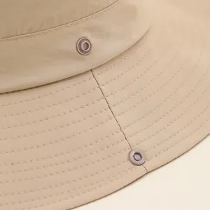 Breathable outdoor sun hat in beige featuring reinforced stitching and metal snap button detail