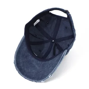 Detail of 100% cotton navy blue washed baseball cap with adjustable metal buckle and vents