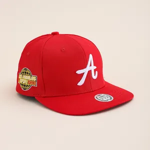 Close-up of red cotton flat brim cap with 3D white A embroidery and LA circular patch