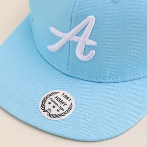 Close-up of light blue baseball cap featuring detailed 3D white embroidered letter A