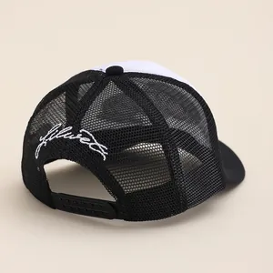 Black and white trucker hat with mesh back and delicate embroidery on the side