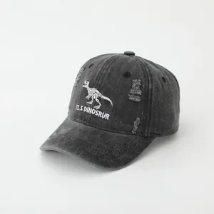 Detail of dinosaur skeleton embroidery on vintage washed charcoal denim baseball cap