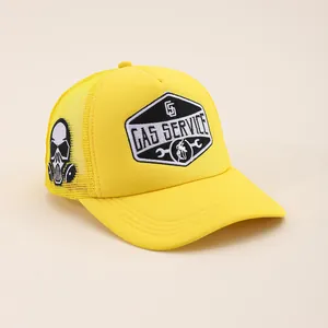 Yellow Gas Service trucker hat with mesh back and side skull embroidery shown at 45-degree angle