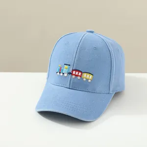 Close-up of colorful train embroidery on light blue washed cotton kid's baseball cap