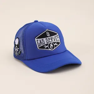 Detail of GAS SERVICE embroidery and gas mask skull patch on blue trucker hat mesh
