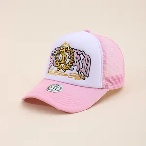 Detail of embroidered STURD patch and holographic sticker on pink mesh trucker cap