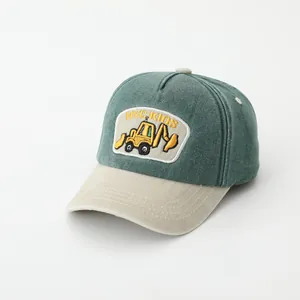 Detail of excavator embroidery and breathable eyelets on kids baseball cap