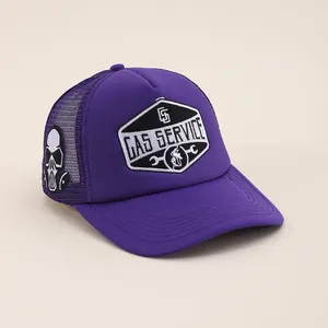Close-up of purple trucker hat featuring Gas Service patch and gas mask skull embroidery