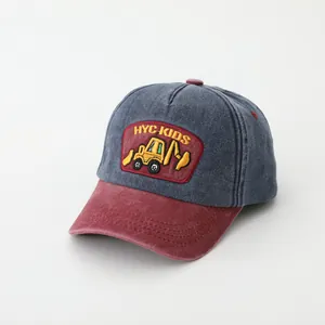Close-up of kids baseball cap featuring an excavator patch and contrast stitching