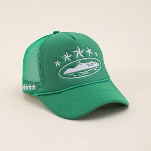Detailed embroidery of white star and scenic patch on a green mesh trucker cap