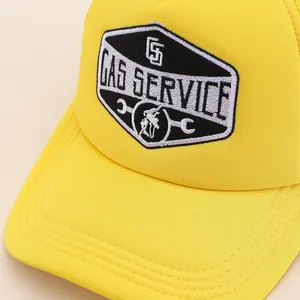 Close-up of yellow trucker hat featuring detailed Gas Service embroidery and worker patch