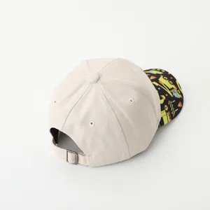 Beige kids baseball cap with excavator pattern shown from a 45-degree back angle view