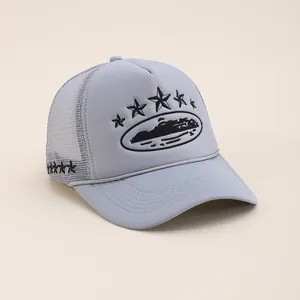 Close-up of light blue trucker hat featuring star embroidery and breathable mesh texture
