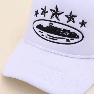 White truckercap with black star embroidery and city silhouette on a woven rope brim