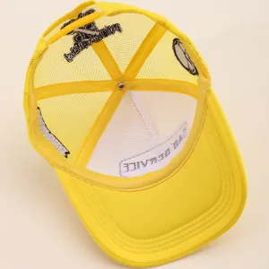 Interior detail of yellow mesh trucker hat showing breathable mesh and embroidery stitching