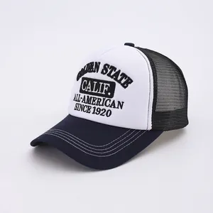 Detail of Golden State embroidery on a mesh trucker hat with blue brim and white front
