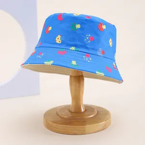 Detail of royal blue kids bucket hat featuring cartoon strawberry and mushroom prints