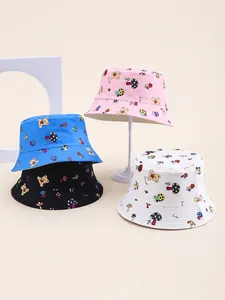Detail of colorful cartoon mushroom and bear patterns on assorted cotton bucket hats for kids