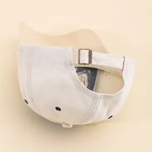 Back view of beige cotton San Francisco baseball cap with adjustable metal strap buckle