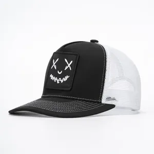 Close-up of the mesh back and graffiti smile face patch on the black trucker hat