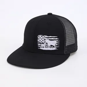 Detail shot of the American flag and cow embroidery on the black mesh trucker hat