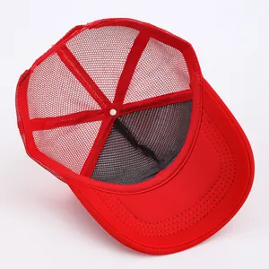 Detail view of bright red mesh trucker hat with durable stitching and breathable back