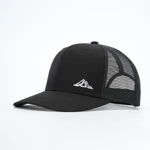 Detailed side view of black trucker hat with white mountain embroidery and mesh back