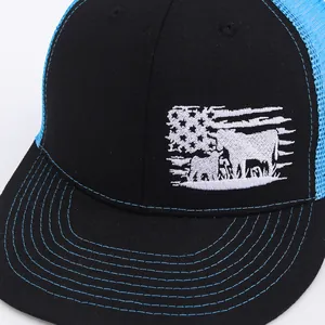Black and blue trucker hat with embroidered USA flag and cattle silhouettes on front