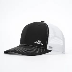 Outdoor trucker hat featuring mountain embroidery and breathable white mesh back panels