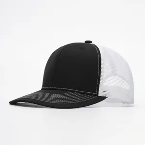 Detail view of the black trucker hat featuring contrast white stitching and breathable mesh