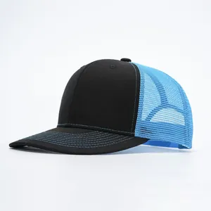 Detail of a trucker hat with black twill crown and light blue breathable mesh back