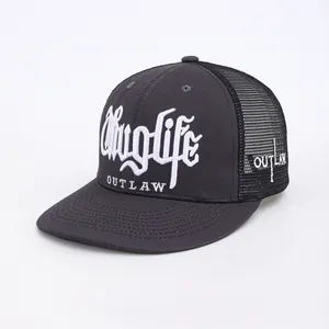 Detail of white Thug Life embroidery on a charcoal grey trucker hat with mesh back