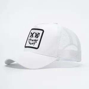 Detail view of the breathable white mesh and street graffiti smile patch on the trucker hat
