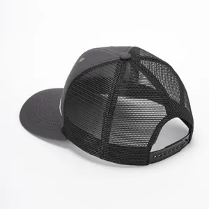 Black mesh trucker hat with mountain embroidery and adjustable snapback closure