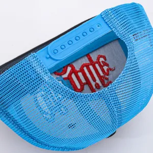Detail of blue trucker hat featuring breathable mesh and adjustable plastic snapback closure
