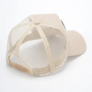 Beige trucker hat with breathable mesh back and adjustable snapback closure