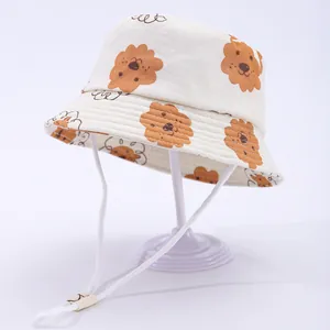 Detail of baby sun hat with brown puppy print, wide brim and adjustable chin strap