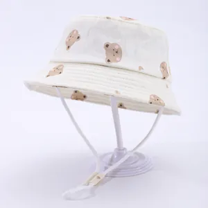 Cute beige cotton baby sun hat with cartoon bear print and adjustable chin strap